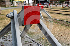 Buffer stop with red painting closeup view on old railroad