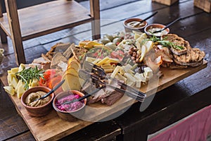 Buffet of assorted cheese cured meat, sausage, ham, fruit, vegetables, olives, pickled, bread and sauce for the event or