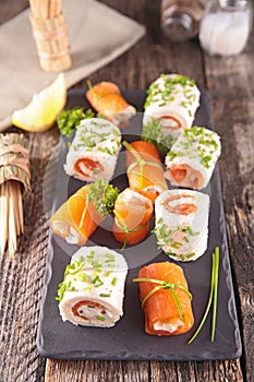 Buffet food, bread rolled up with cream and smoked salmon