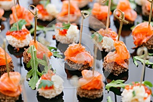 Buffet at the gala dinner. Assortment of canapes. Banquet service. catering food, snacks with salmon and caviar. rye