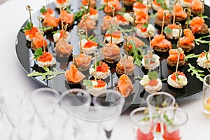 Buffet at the gala dinner. Assortment of canapes. Banquet service. catering food, snacks with salmon and caviar. rye