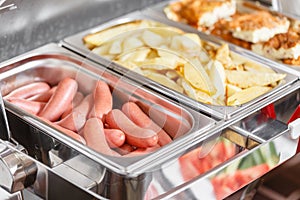 Buffet heated trays ready for service. Breakfast in hotel smorgasbord.