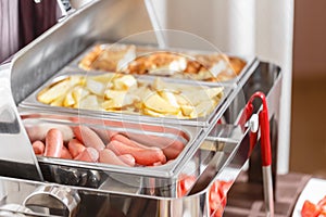 Buffet heated trays ready for service. Breakfast in hotel smorgasbord.