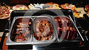 Buffet heated trays with sausages, in hotel luxury restaurant. All inclusive. Buffet food. Hotel serves buffet for breakfast.