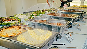 Business catering people take buffet food during company event