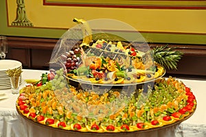 Buffet platter of canapÃ©s decorated in birds of Paradise peacock.