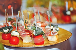 Buffet at the reception. Glasses of wine and champagne. Assortment of canapes on a wooden board. Banquet service. food, snacks