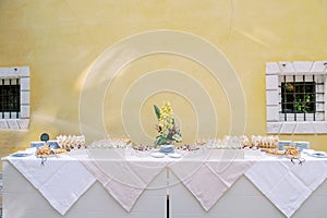 Buffet with small snacks and sandwiches stands against the wall of the building