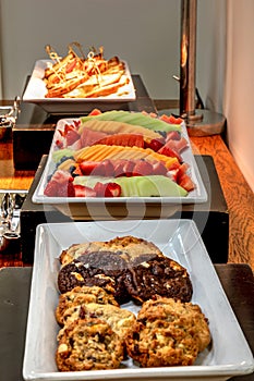 Buffet spread including grilled Reuben sandwiches under a heater