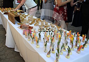 Buffet table with cut vegetable hors d`oeuvres on a white tablecloth
