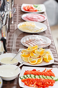 Buffet trays heated ready for service. Breakfast in hotel smorgasbord. Plates with different food