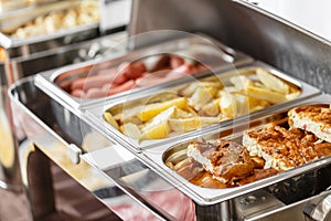 Buffet trays heated ready for service. Breakfast in hotel smorgasbord. Plates with different food