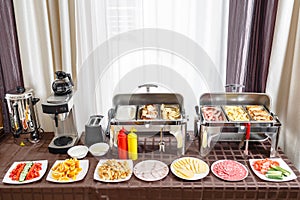 Buffet trays heated ready for service. Breakfast in hotel smorgasbord. Plates with different food