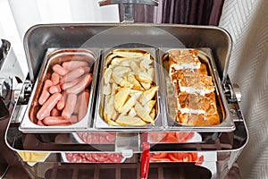 Buffet trays heated ready for service. Breakfast in hotel smorgasbord. Plates with different food