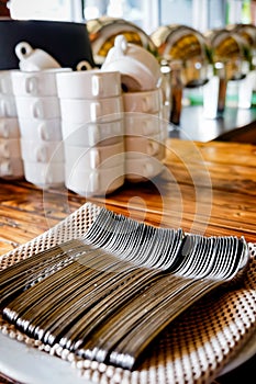 Buffet Utensil Set in Neat and Tidy Arrangement on Vintage Wooden Table in a Restaurant or Cafe
