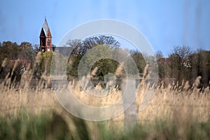 Bugenhagen church in Greifswald-Wieck, Germany with selective focus and blue sky