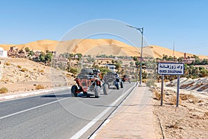 Buggy cars riding on the road to the big sand dune of Taghit.