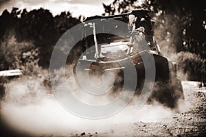 Buggy quickly passing a country road in clouds of dust