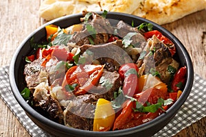 Buglama Traditional hot ragout with meat and vegetables closeup in the Bowl. Horizontal photo