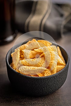 Bugles snack. Cone corn chips in bowl on kitchen table