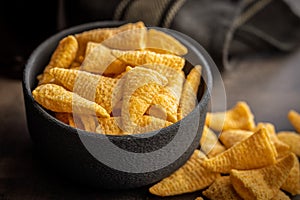 Bugles snack. Cone corn chips in bowl on kitchen table