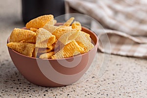 Bugles snack. Cone corn chips in bowl on kitchen table
