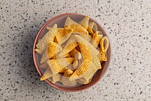 Bugles snack. Cone corn chips in bowl on kitchen table. Top view