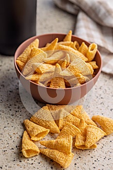 Bugles snack. Cone corn chips on kitchen table