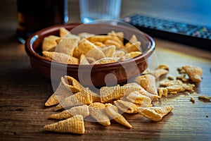 Bugles snack. Cone corn chips on wooden table