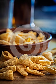 Bugles snack. Cone corn chips on wooden table
