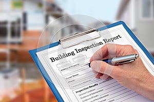 Buiding Inspector completing an inspection form on clipboard photo