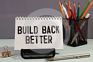 Build back better written in white chalk on a black chalkboard isolated on white photo