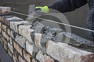Build a brick wall, bricklaying spreading a bed joint photo