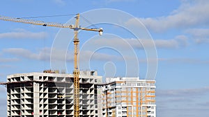 Build crane jib and unfinished skyscraper building with clouds in sky