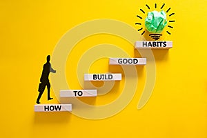 Build good habits symbol. Wooden blocks on beautiful yellow background, copy space. Words `How to build good habits`. Businessma