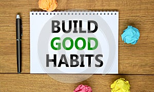 Build good habits symbol. Words `Build good habits` on beautiful wooden table, colored paper, black metallic pen. Business,