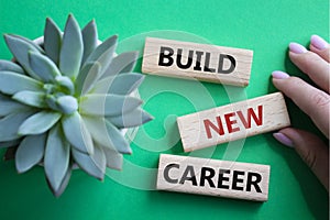 Build new career symbol. Concept word Build new career on wooden blocks. Businessman hand. Beautiful green background. Business