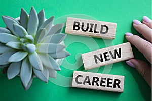 Build new career symbol. Concept word Build new career on wooden blocks. Businessman hand. Beautiful green background. Business