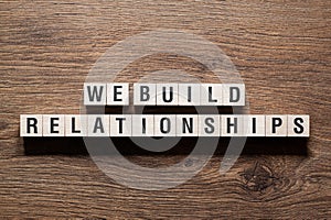 We build relationships - word concept on building blocks, text