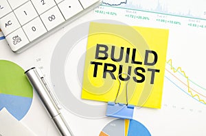 BUILD TRUST Concept. Calculator,pen and glasses on the white background