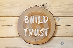 Build trust symbol. Concept words Build trust on beautiful wooden circle. Beautiful wooden wall background. Business and build