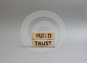 Build trust symbol. Wooden blocks with words Build trust. Beautiful grey background. Business and Build trust concept. Copy space