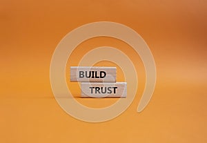 Build trust symbol. Wooden blocks with words Build trust. Beautiful orange background. Business and Build trust concept. Copy