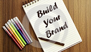 Build Your Brand. your future target searching, a marker, pen, three colored pencils and a notebook for writing