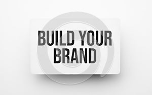 Build Your Brand sign on notepad on the white backgound