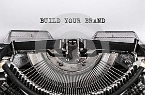 BUILD YOUR BRAND typed words on old vintage typewriter. close up