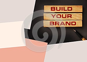 Build your Brand written on wooden blocks with vintage styled background. Branding rebranding marketing concept