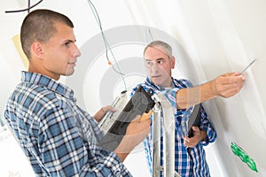 Builder applies glue on wall for ceramic tile