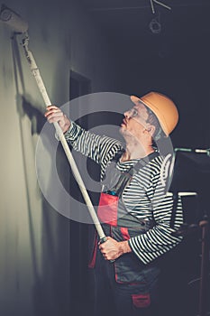 Builder applying paint