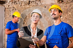 Builder and architect discussing on construction site